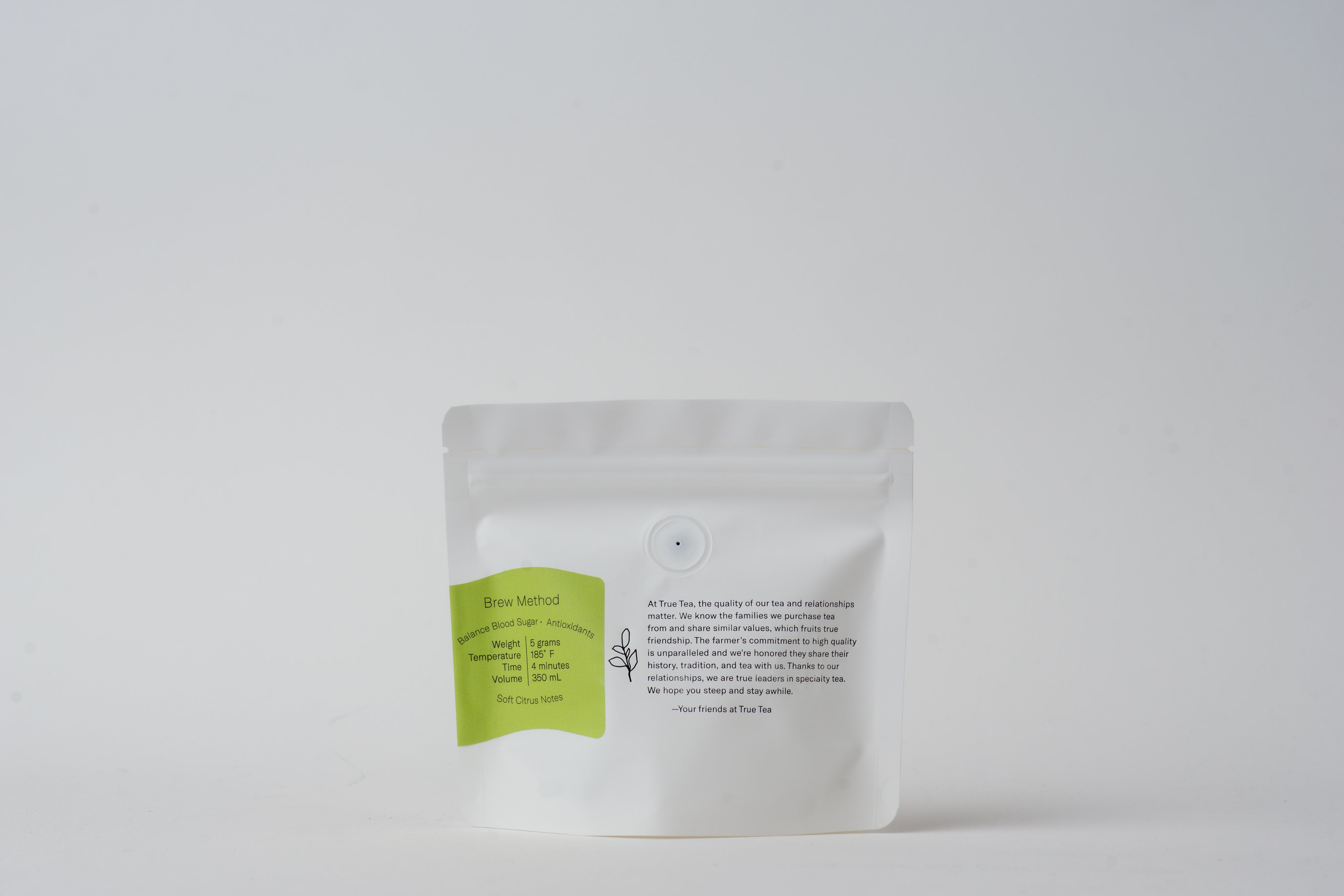 Back of a white package with a light green label. Package contains loose leaf Organic Genmaicha tea from True Tea, a tea company based in Portland, Oregon